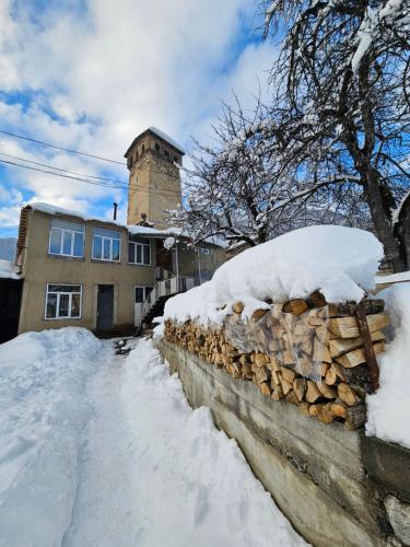 a stone wall with snow on top of it at Guest House Ketevan Niguriani in Mestia