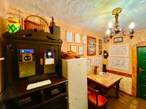 a kitchen with a refrigerator and a table in a room at Etno selo Stanojevic in Boljevac