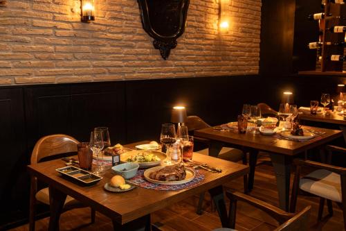 a dining room with two tables with plates of food at Riu Palace Baja California - Adults Only - All Inclusive in Cabo San Lucas