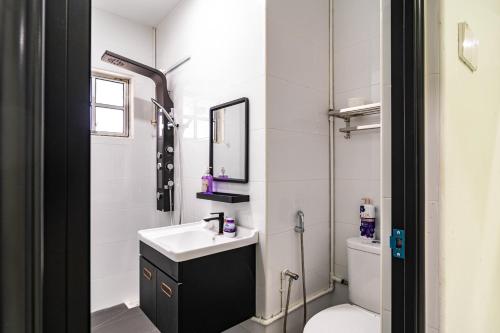 a white bathroom with a sink and a toilet at 10 mint drive to Mid Valley KL near Gateway Bangsar Seputeh in Kuala Lumpur