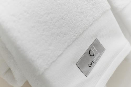 a close up of a white towel on a bed at Carris Casa de la Troya in Santiago de Compostela