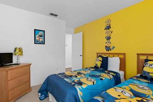 a bedroom with two beds and a tv in it at Quiet house with pool on a Top golf course in Haines City