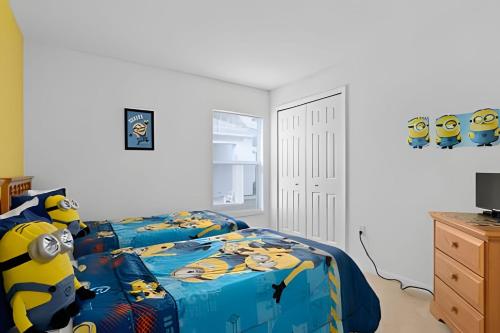 a bedroom with a bed with a disney comforter at Quiet house with pool on a Top golf course in Haines City