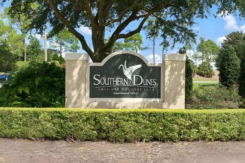 a sign for the southern dunes golfery at Quiet house with pool on a Top golf course in Haines City