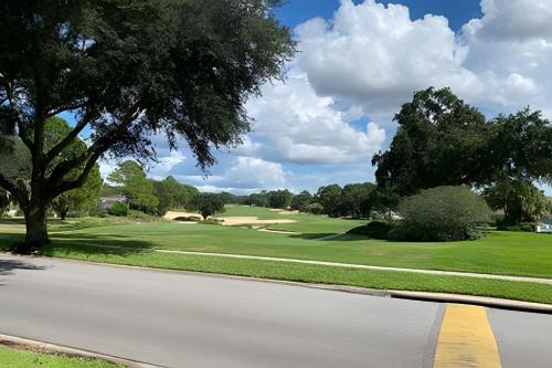a view of a golf course from the road at Quiet house with pool on a Top golf course in Haines City