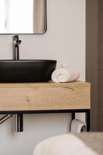a bathroom counter with a sink and a towel at Le Petit Boutique Hotel in Santander