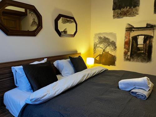 a bedroom with a large bed with two pillows at Kauno Senamiestis in Kaunas