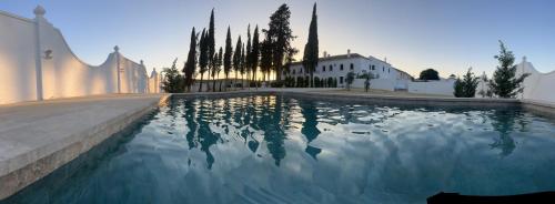 a pool of water in front of a building at Cortijo El Solano in Antequera