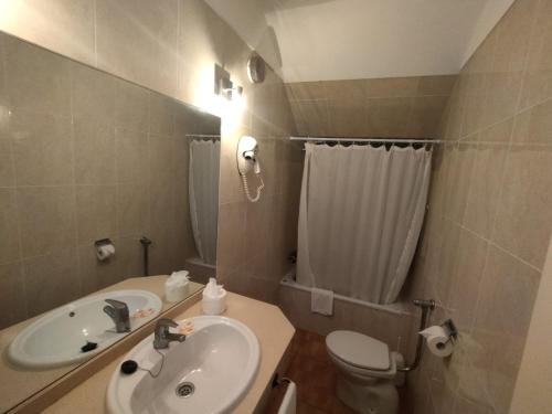 a small bathroom with a sink and a toilet at Hotel Casa del Sol in Puerto de la Cruz