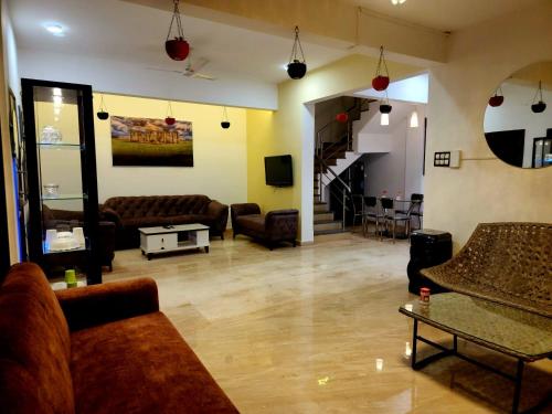 a large living room with couches and a table at ReUnion Villa ll Swimming Pool ll Snooker ll AC ll BBQ ll 3BHK in Lonavala