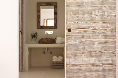 a sliding door in a bathroom with a mirror at A beautiful villa close to the beach in Playa Migjorn