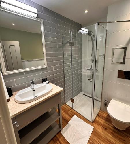 a bathroom with a sink and a shower at Predela 2 Aparthotel in Bansko