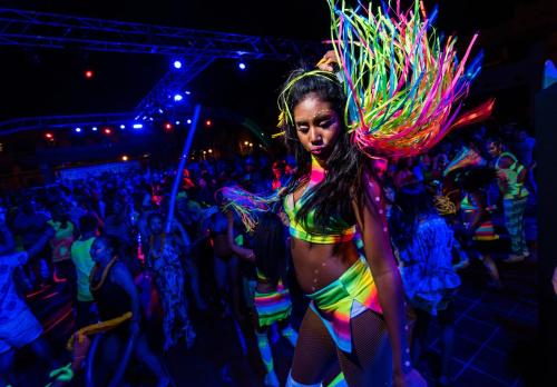 a woman in a colorful costume at a party at Riu Palace Baja California - Adults Only - All Inclusive in Cabo San Lucas
