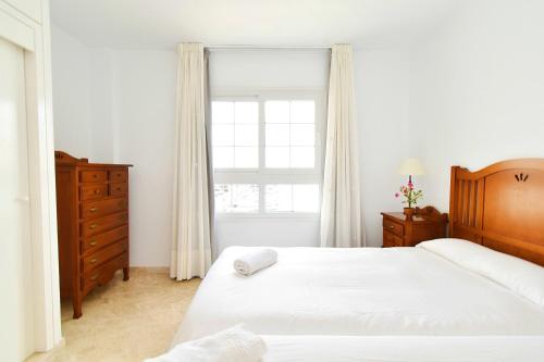 a bedroom with two beds and a window at Expoholidays - Puerto Deportivo La Goleta in Almerimar