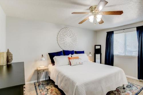 a bedroom with a white bed and a ceiling fan at Right off i215 Close to Ski Resorts and Mountains in Cottonwood Heights