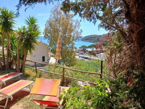 a patio with chairs and a view of the ocean at Case Vacanze Maestrale in Fetovaia