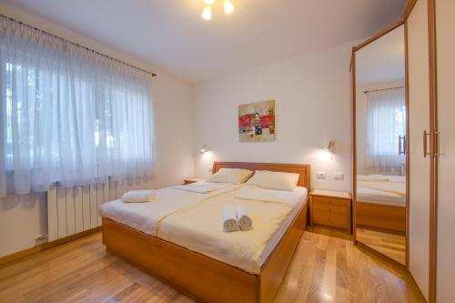 a bedroom with a large bed with towels on it at Villa Cera Dignano in Vodnjan