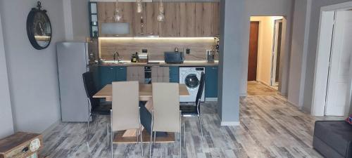 a kitchen with a table and a dining room at Узунови Апартамент Трявна леик in Tryavna