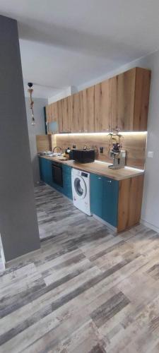 a kitchen with a sink and a washing machine at Узунови Апартамент Трявна леик in Tryavna