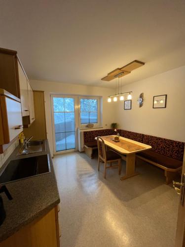 a kitchen with a table and a dining room at Appartement Riepler in Wagrain