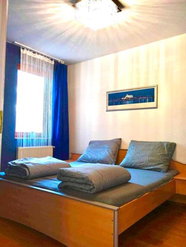 a bed with two pillows on it in a room at Zen Apartman in Budakalász