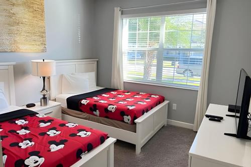 a bedroom with two beds with hello kitty sheets at Wonderful home close to disney & universal in Kissimmee