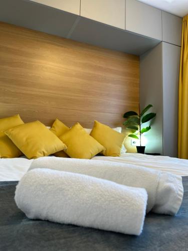 a bedroom with two beds with yellow pillows at Bulgarane House in Govedartsi