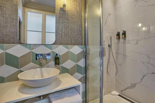 a bathroom with a sink and a shower at Le Robinet d'Or Paris Canal Saint Martin in Paris