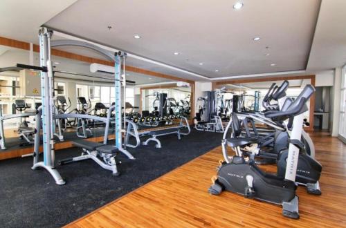 a gym with treadmills and elliptical machines at Apartement Vida View, 2BR comfy place by Als in Pampang