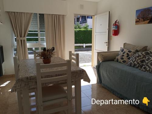 sala de estar con mesa y sofá en Jacarandá- A 50 mts de la av principal- Planta baja- Casa o Departamento en Federación