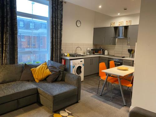a living room with a couch and a kitchen at Mia's Place 24 in Chester
