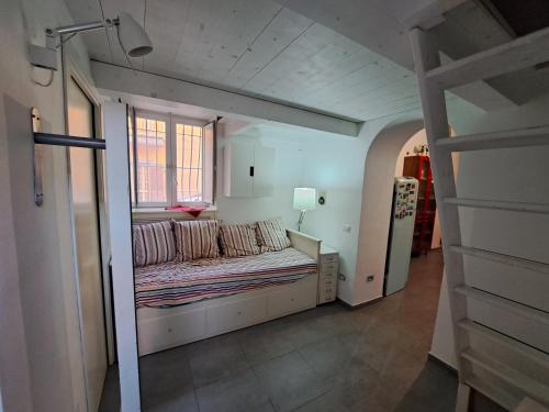 a room with a couch in a room with a window at Carmela Camera&Comfort Monolocale in Caserta