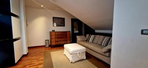 a living room with a couch and a stool at 108 APARTMENT - Torino in Turin