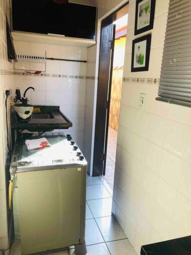 a kitchen with a stove and a sink in a room at Bertioga Casa pertinho da Praia in Bertioga