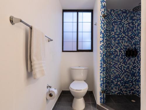 a bathroom with a toilet and a shower at Penthouse Chicalá Colombian Experience in Parque Virrey in Bogotá