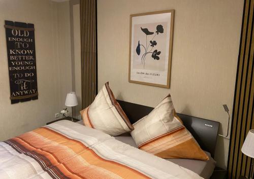 a bedroom with a bed with pillows on it at Ferienwohnung Feiden Eifel-Mosel Lounge in Greimersburg