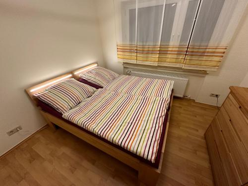 a bed in a small room with a window at FeWo-Schwarzer in Ingelheim am Rhein