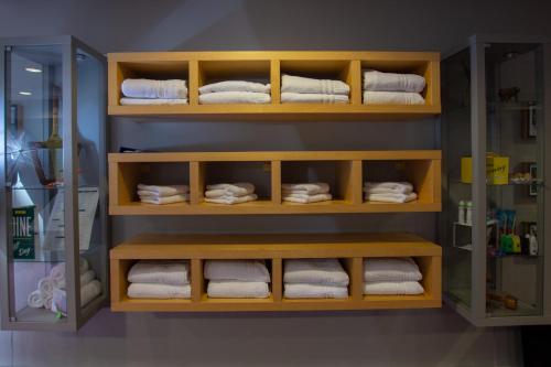 a bathroom with towels on a shelf with towels at Holiday Inn Liverpool City Centre by IHG in Liverpool
