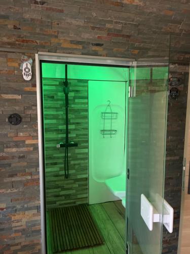 a bathroom with a shower with a glass door at Rêves de vie le "port pin" vue mer, petite piscine, jacuzzi, parking PRIVES in Cassis