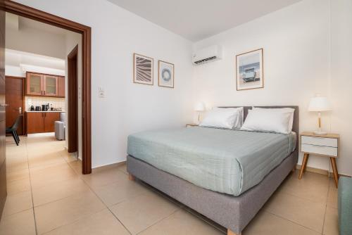 a bedroom with a bed and a living room at Kyma 4 - 5 min to Beach in Kos Town