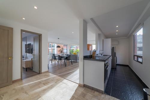 an open kitchen and living room in a house at Penthouse Chicalá Colombian Experience in Parque Virrey in Bogotá