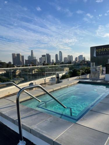 a swimming pool on top of a building with a city skyline at Luxury Downtown Los Angeles Penthouse Condo with Skyline Views in Los Angeles