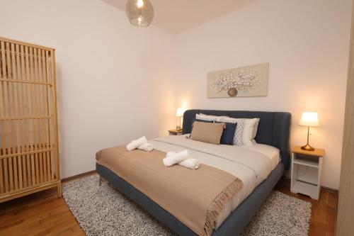 a bedroom with a large bed with towels on it at Ruby holiday home with patio in Vienna