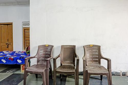 three chairs sitting in a room with a bed at OYO Hotel Neelkamal palace and Guest house in Nāthdwāra