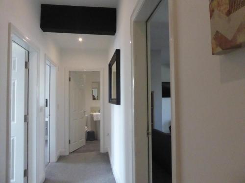 a hallway leading to a bathroom with a mirror at Mia's Place 24 in Chester