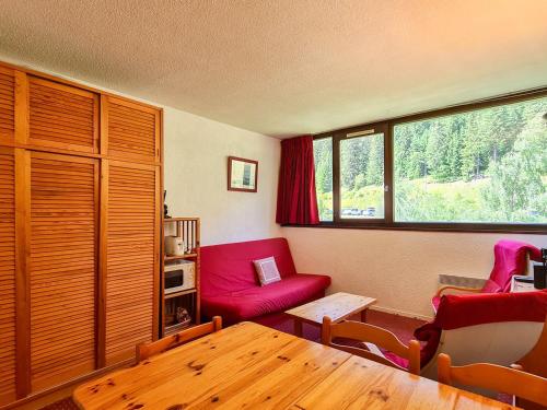 un salon avec un canapé rouge et une table dans l'établissement Studio confortable Proche des pistes Casier à ski - FR-1-425-79, à Flaine