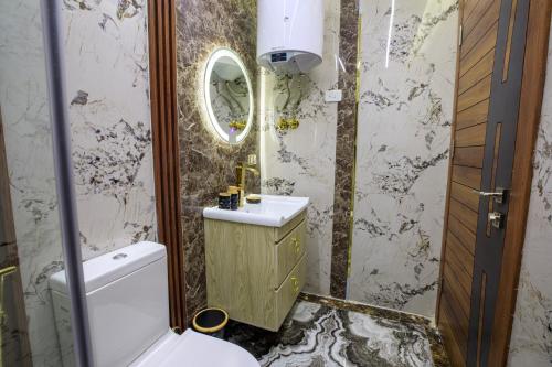 a bathroom with a toilet and a sink and a mirror at Piccolo Mondo Boutique Hotel in Cairo