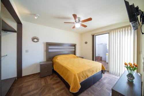 a bedroom with a bed and a ceiling fan at Apartamentos Posada Country in Guadalajara
