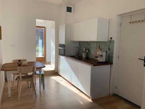 a kitchen with a table and a dining room at Appartement centre ville avec terrasse in Lille