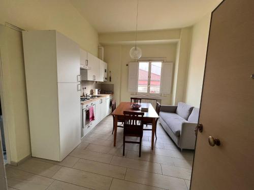 a kitchen and dining room with a table and a couch at La Piazzetta in Avellino